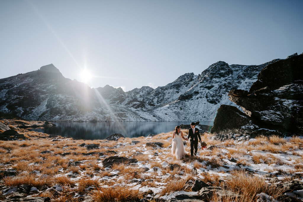 bride and groom exploring lake Hope in queenstown new zealand