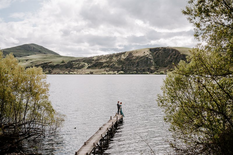 bride and group by a lake