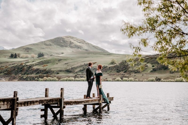 bride and group by a lake