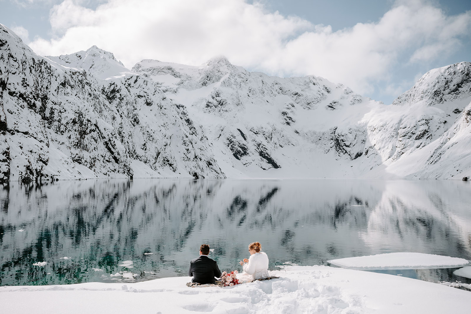 bride and groom by the lake winter elopement in queenstown