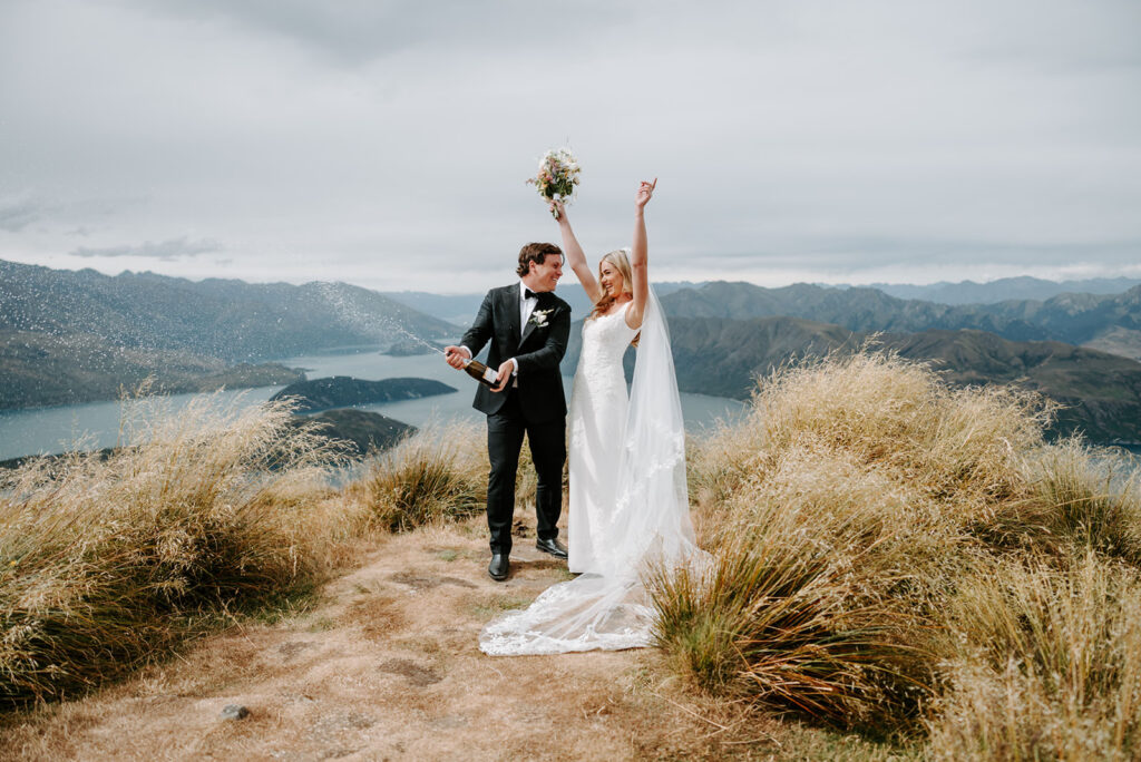 bride and groom popping champagne after their elopement in Queenstown New Zealand