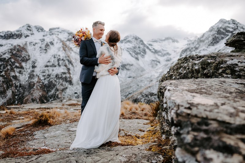 and and groom smiling at each other at roundhill in queenstown