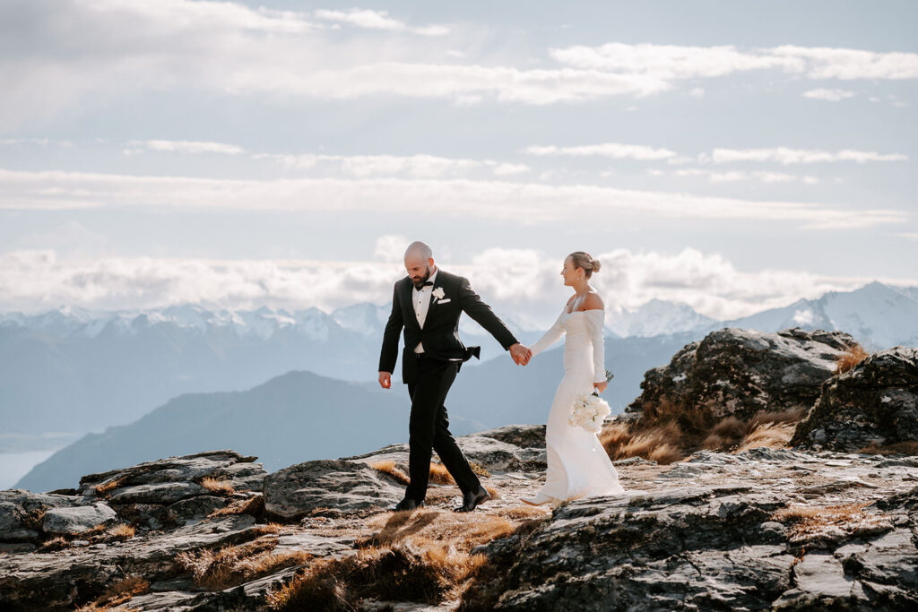 bride and groom exploring cecil peak after their laidback elopement in queenstown NZ