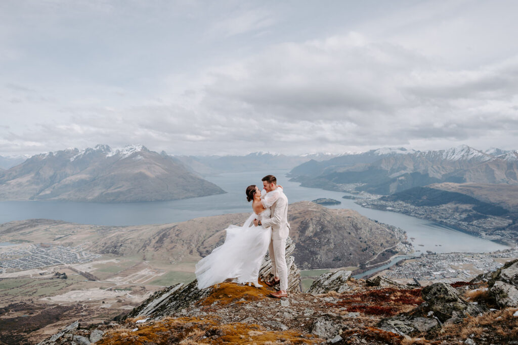 bride and groom on top of cecil peak after elopement in queestown nz