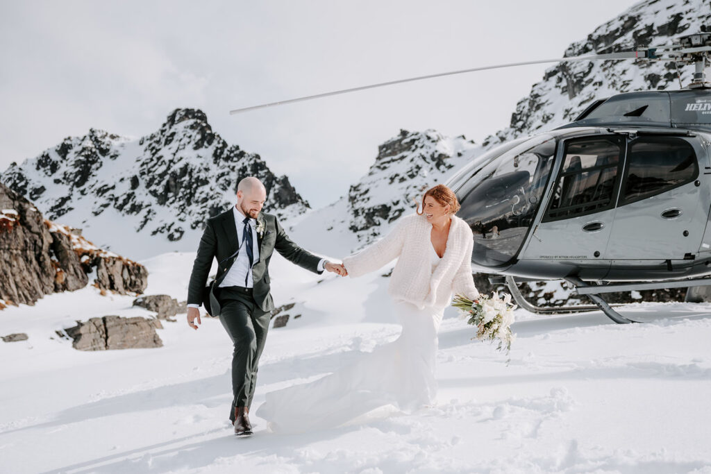 bride and groom walking in snow at Cecil Peak Queenstown for their adventure elopement in NZ